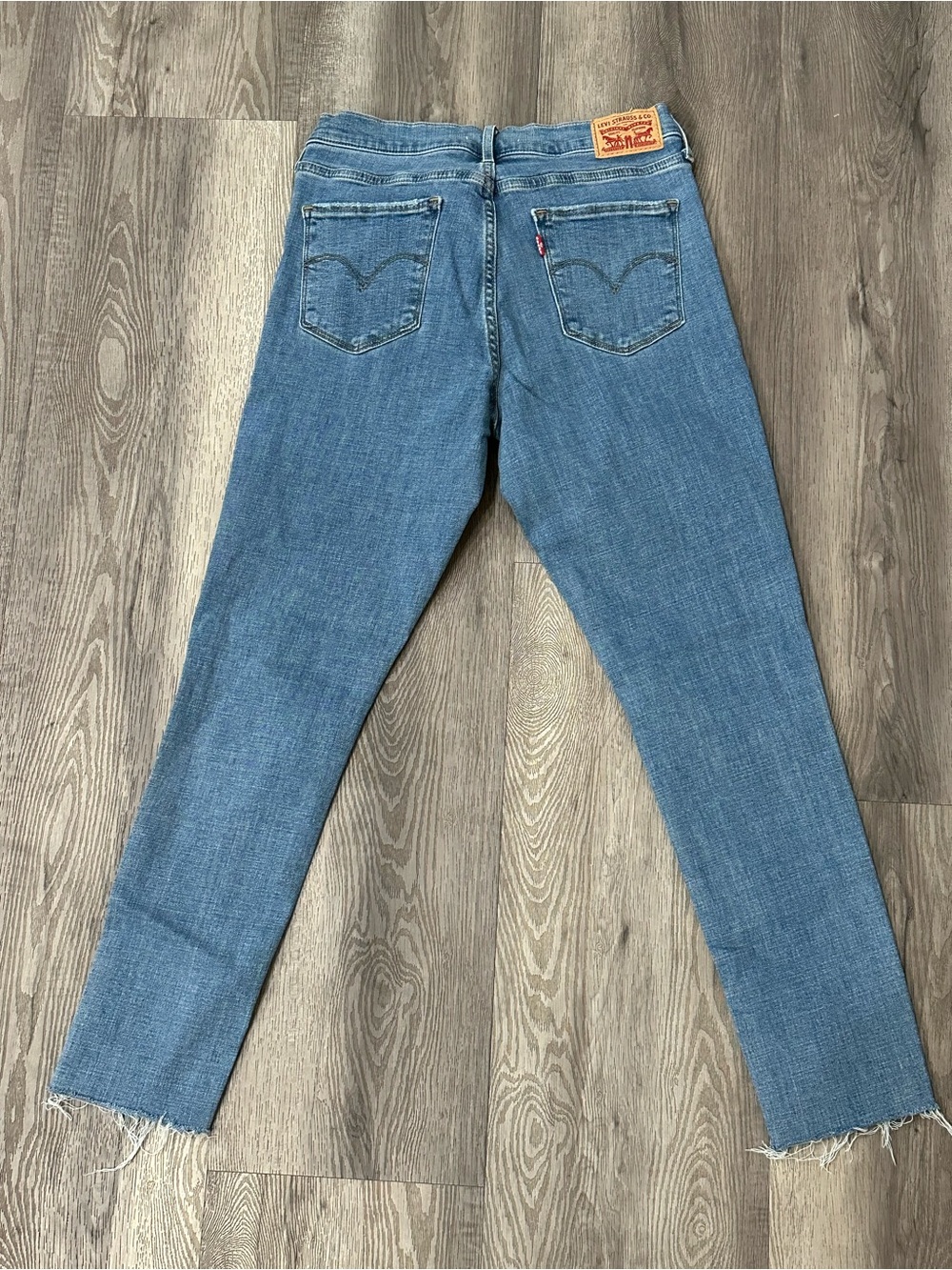 Levi’s 311 Shaping Skinny Blue Jeans size 29 distressed bottom legs
